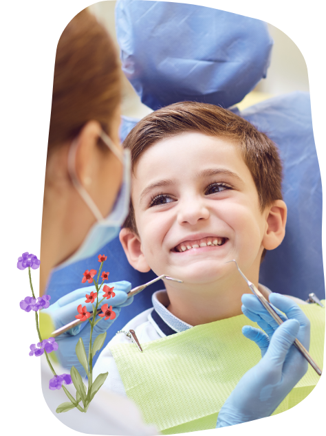 Young child smining in dental chair