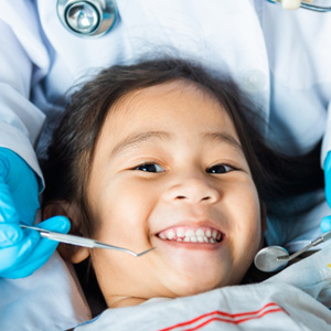 Little girl smiling about to have teeth examined
