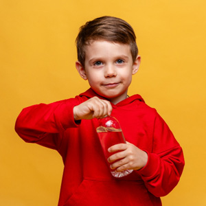 Little boy in red hoody trying to open bottle of water