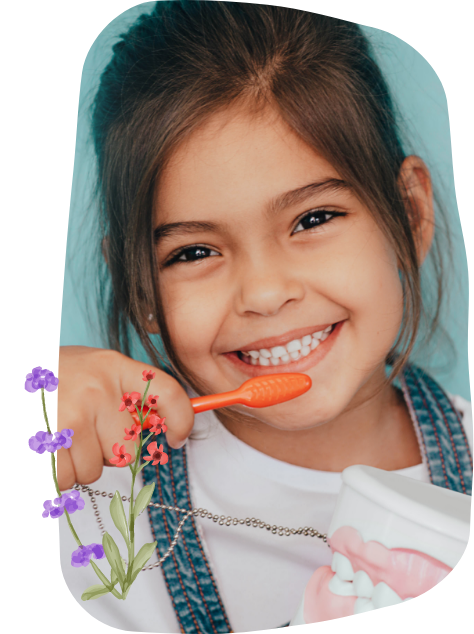 Young girl in overalls smiling outdoors