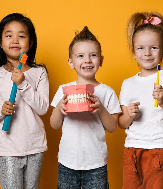 Little girl high-fiving dental team member