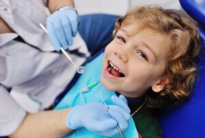 Child smiling during his checkup and cleaning