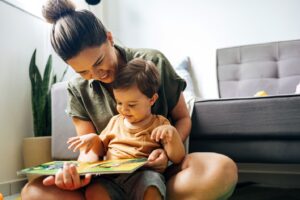 Mother reading book with child.