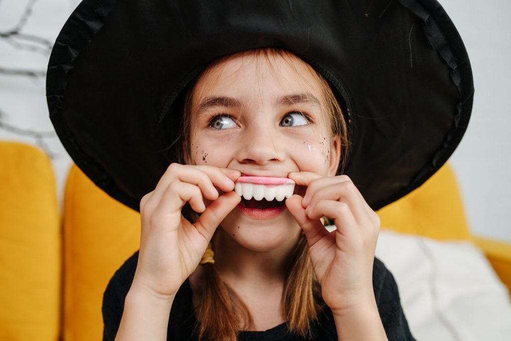 A little girl in a witch costume